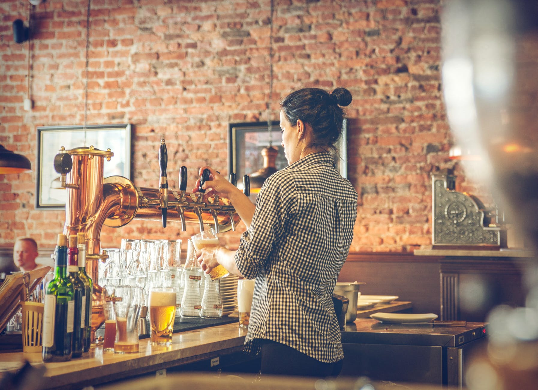 photo of bartender pouring draught beer