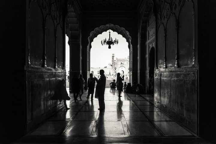 monochrome photography of people inside building