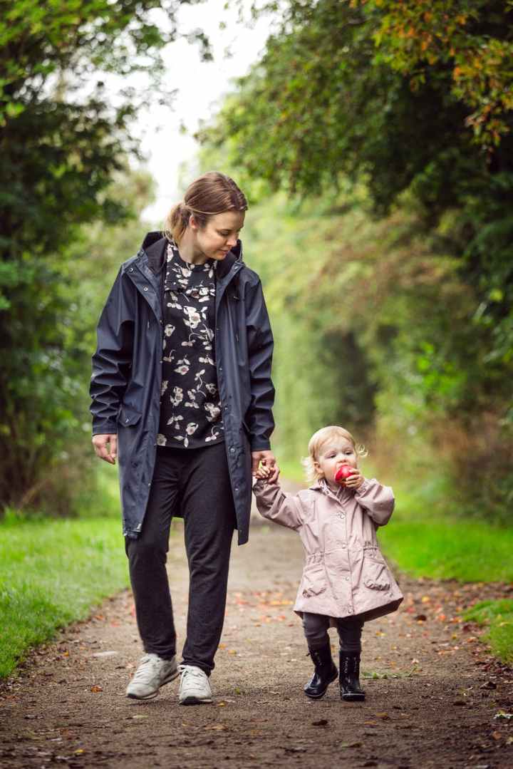 woman walking with child on pathway