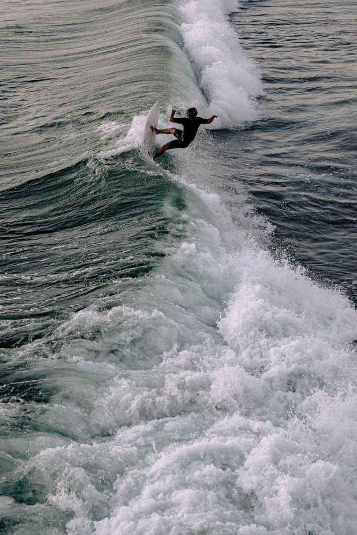 photo of person surfing on the sea